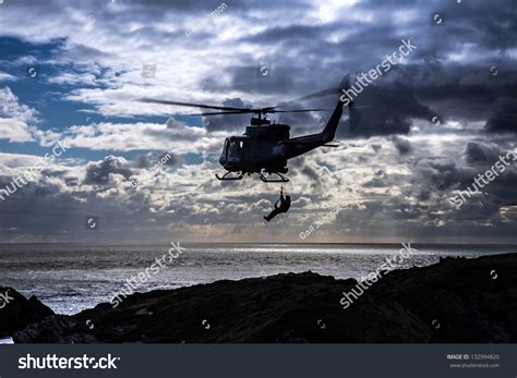 Griffin Helicopter Hovering Off The Coast Of The Isle Of Anglesey North