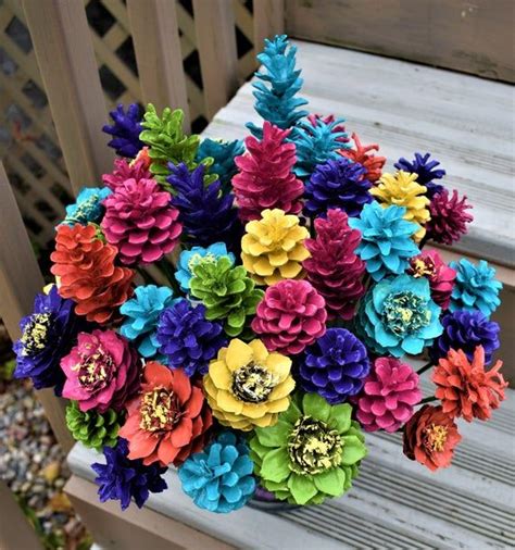 A Bouquet Of Colorful Flowers Sitting On Top Of A Wooden Bench