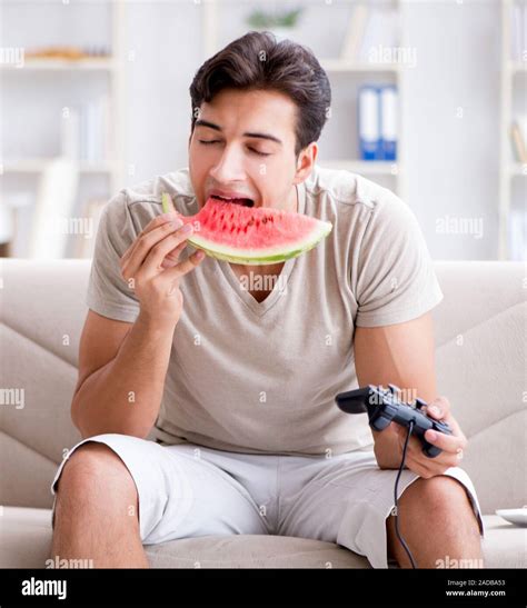 Man Eating Watermelon At Home Stock Photo Alamy