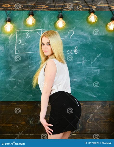 Lady Teacher In Short Skirt Looking Back While Explaining Formula Teacher Concept Woman With