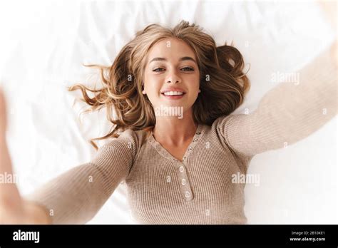 Photo Of Young Cheerful Woman With Blonde Hair Taking Selfie Photo And