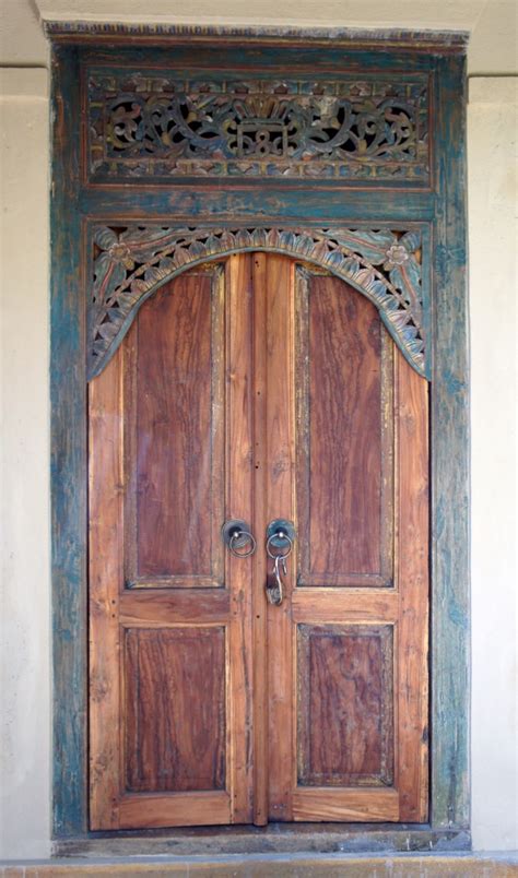 An Old Wooden Door With Ornate Carvings On It