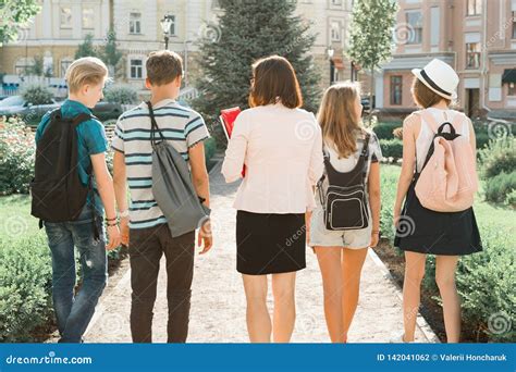 Outdoor Portrait Of School Teacher And Group Of Teenagers High School