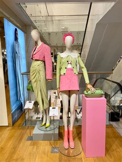 Two Mannequins Dressed In Pink And Green Outfits