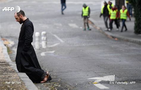 A priest in the middle of the French protests : r/Catholicism