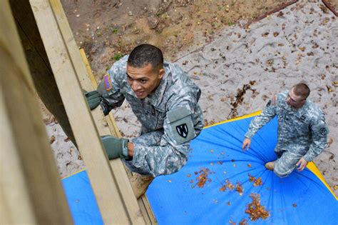 U S Army Spc James Simo Left Negotiates An Obstacle During The