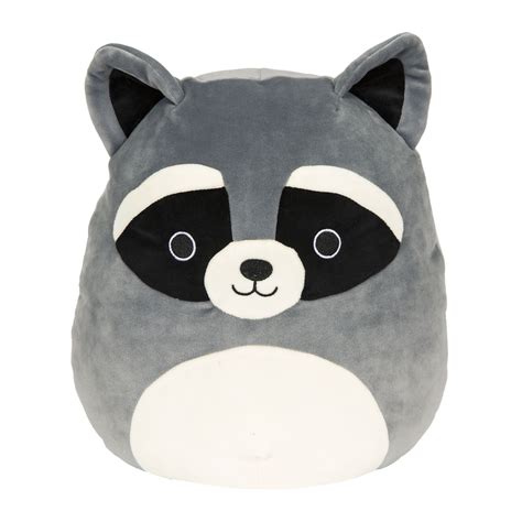 A Stuffed Raccoon Is Sitting On Top Of A White Surface And Its Eyes