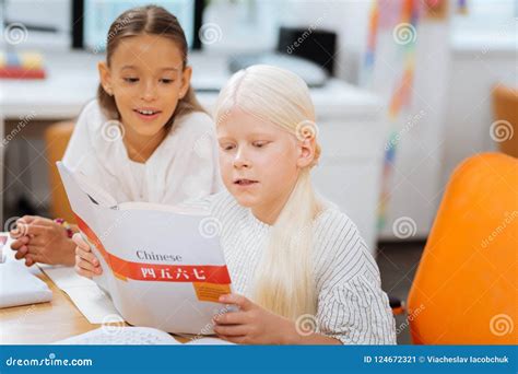 Clever Girls Reading A Book Very Attentively Stock Image Image Of