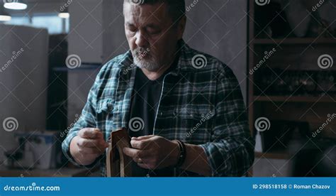 Successful Mature Craftsman Restores Items Made From Leather And