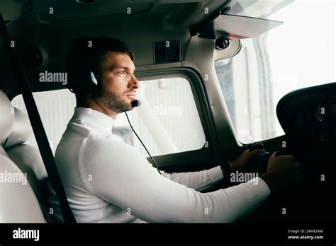 Focused Handsome Bearded Pilot In Headset In Plane Stock Photo Alamy