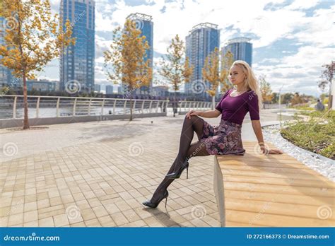 Blonde Woman With Perfect Legs In Pantyhose And Shoes With High Heels