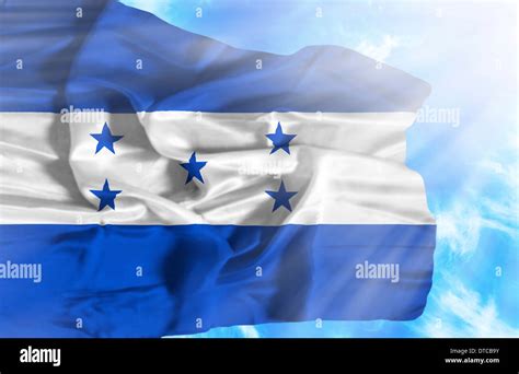 Honduras Waving Flag Against Blue Sky With Sunrays Stock Photo Alamy