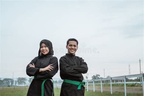 Male And Female Fighters Wearing Pencak Silat Uniforms Perform Side