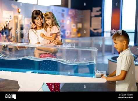 Mom with kids visit a science museum Stock Photo - Alamy