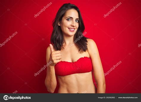 Beautiful Woman Wearing Bikini Swimwear Red Isolated Background Doing