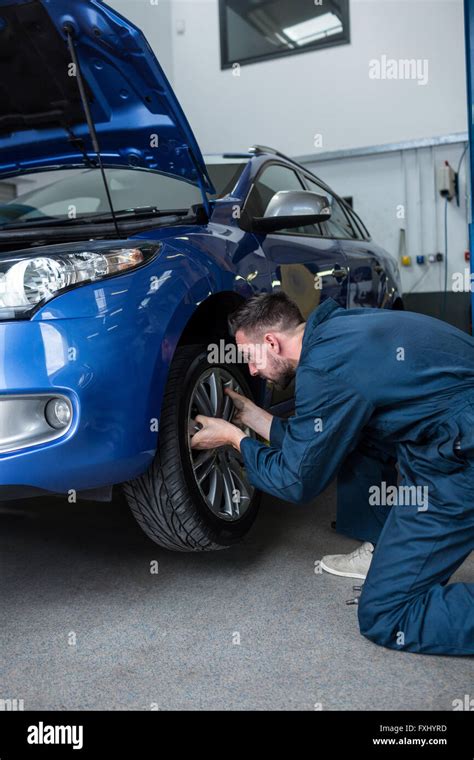 Mechanic Fixing A Car Wheel Stock Photo Alamy