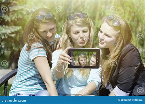 Three Happy Young Girlfriends Doing Selfie By Phone Stock Image Image