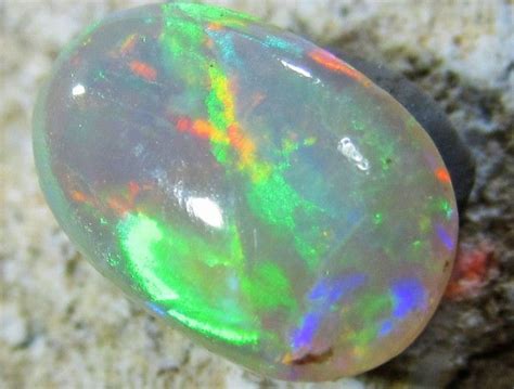 An Opalite Stone Sitting On Top Of A Rock