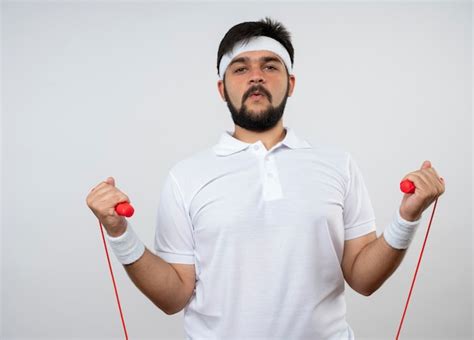 Free Photo Confident Young Sporty Man Wearing Headband And Wristband