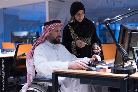 Handicapped Arabic Businessman In Tradition Suit With Female Arabic