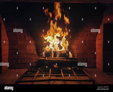 Roaring fire in a large rustic stone fireplace Stock Photo - Alamy