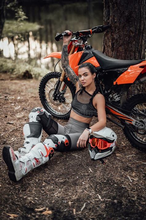 Sensual Tattooed Racer Girl Wearing Motocross Outfit With Semi Naked