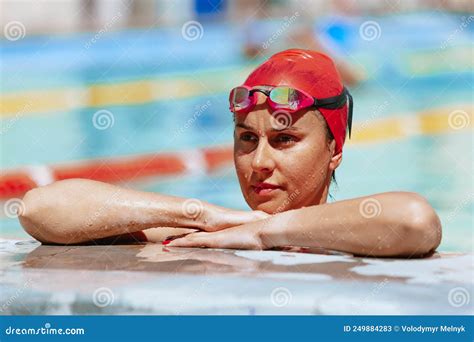 Young Beautiful Woman In Swimming Cap And Goggles Having Rest At