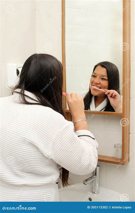 Latina Year Old Woman Brushes Her Teeth To Prevent Cavities Dressed In Bathrobe In The