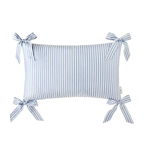 A Blue And White Striped Pillow With Bows