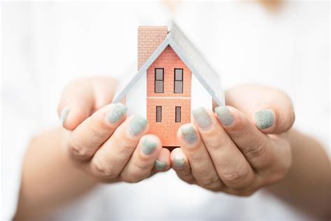 Woman Holding A House Model With Two Hands 9312043 Stock Photo At Vecteezy