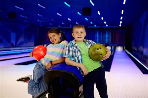 Two Children with Balls Poses in Bowling Alley Stock Photo - Image of ...