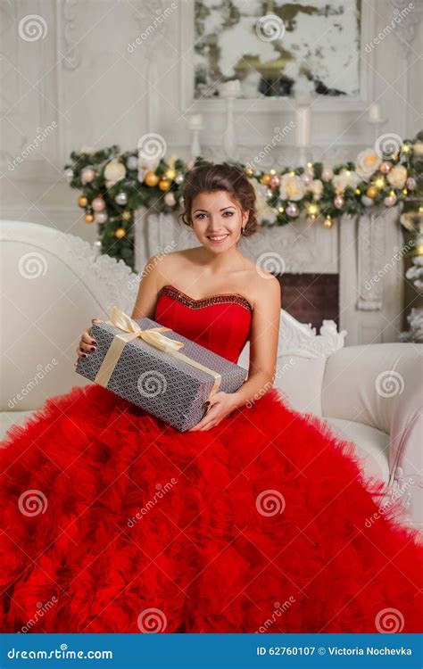 Beautiful Smiling Brunette Sitting On Couch Holding Christmas Gift Stock Image Image Of Girl