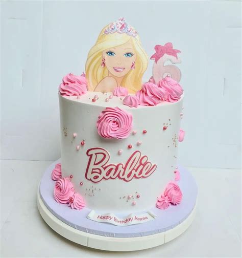 A Barbie Birthday Cake With Pink Frosting And Roses