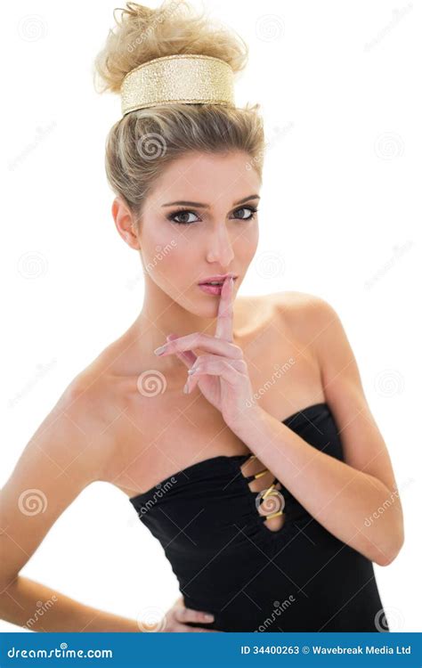 Calm Blonde Model With Big Hairstyle Putting Her Finger To Lips Stock