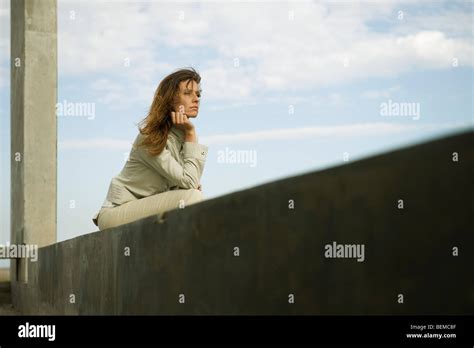 Woman Leaning On Elbow Contemplatively Looking Away Stock Photo Alamy