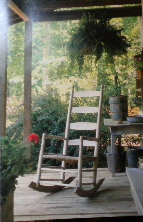 Two Rocking Chairs Sitting On A Porch Next To A Fire Place