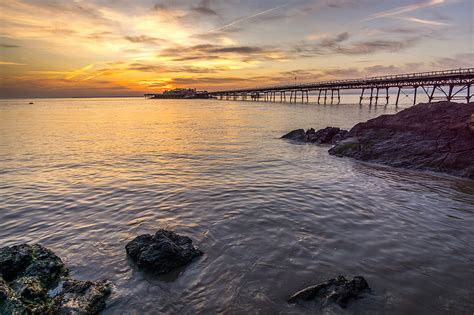 Pier Stones Sea Sunset Horizon Hd Wallpaper Peakpx