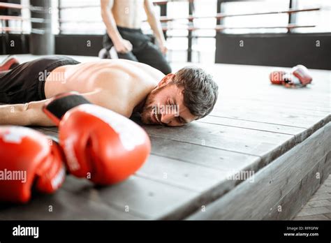 Beaten Boxer Lying On The Floor During A Boxing Battle Having A