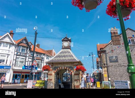 People walking in Sheringham town centre on a hot summer day, with the historic clock building ...