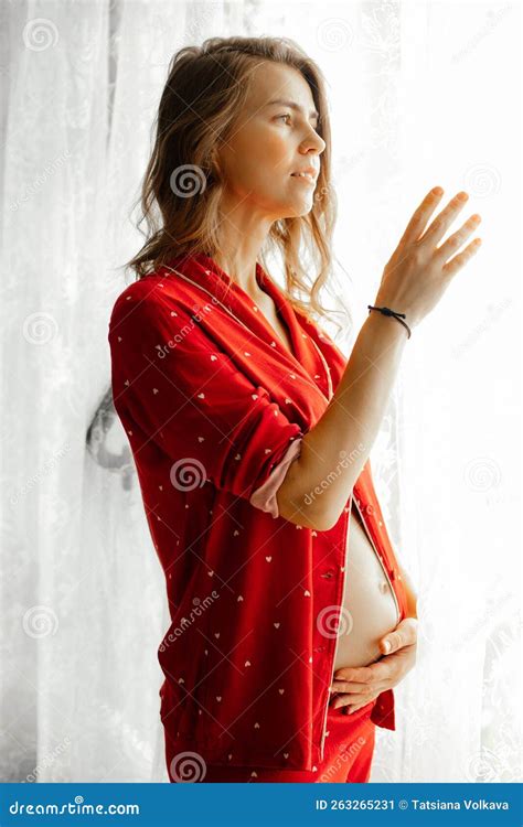 Side View Of Middle Aged Pregnant Woman With Long Wavy Dark Hair