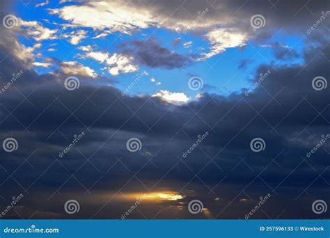 Bright Sunset Sky With Fluffy Clouds Over A Seashore Stock Image