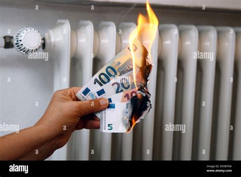 Hand With Burning Euro Bills Price Increase Of Heating Stock Photo Alamy