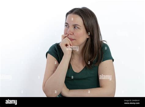 Pensive Young Brunette Woman Gazing At The Sky With Her Hand On Her
