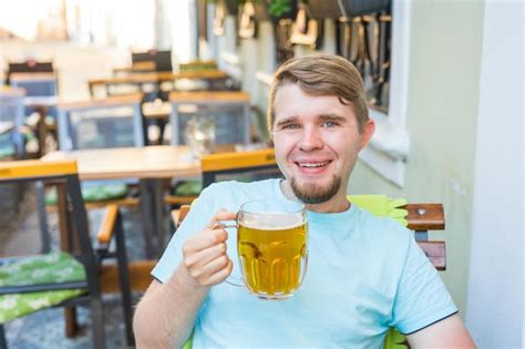 Premium Photo Portrait Of Smiling Young Man Drinking Glass At Restaurant