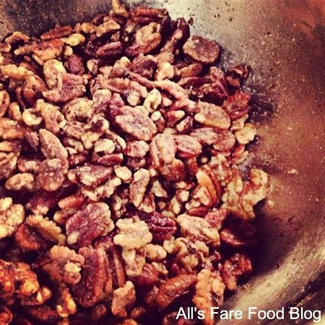 Nuts Are In A Metal Bowl On Top Of A Stove Burner With The Words All S