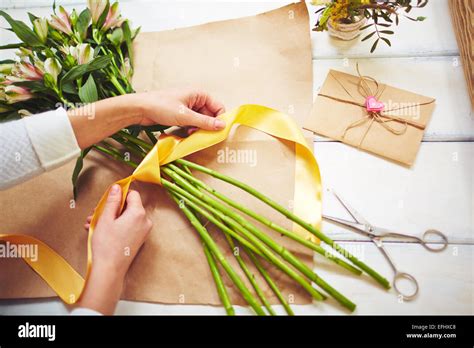 Female Florist Tying Up Fresh Flowers With Silk Ribbon Stock Photo Alamy