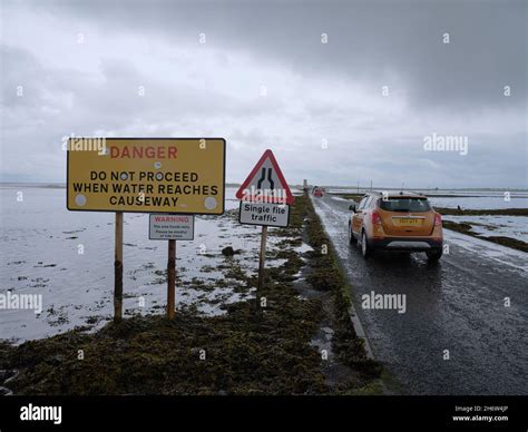 Cars crossing Lindisfarne Causeway a tidal causeway linking the ...