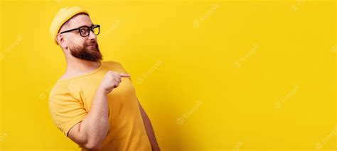 Premium Photo Smiling Bearded Man In Glasses Pointing Over Empty