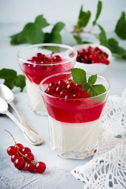 Premium Photo Panna Cotta With Red Currant Jelly In Vintage Glass