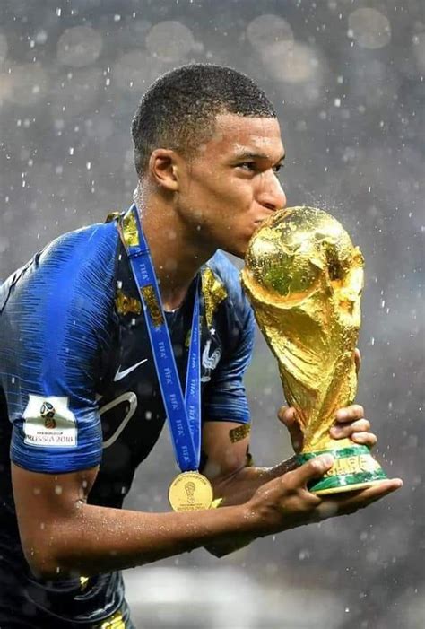 Soccer Player Kissing The World Cup Trophy With Rain Falling Down On